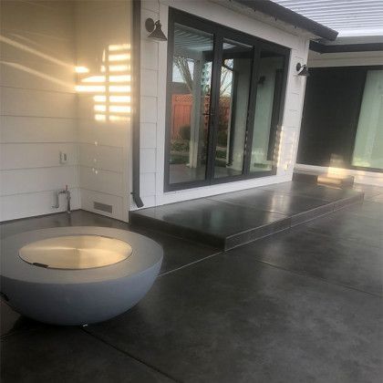 There is a fire pit in the middle of the patio.