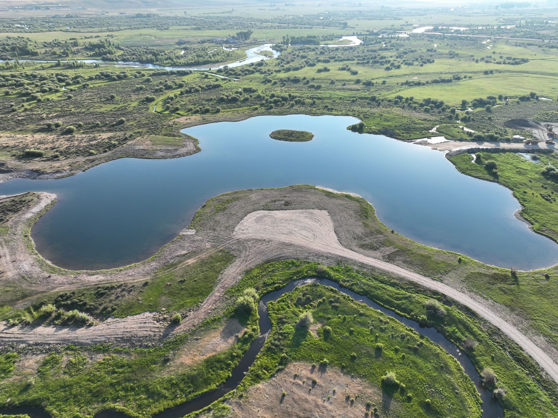An aerial view of a lake with a small island in the middle