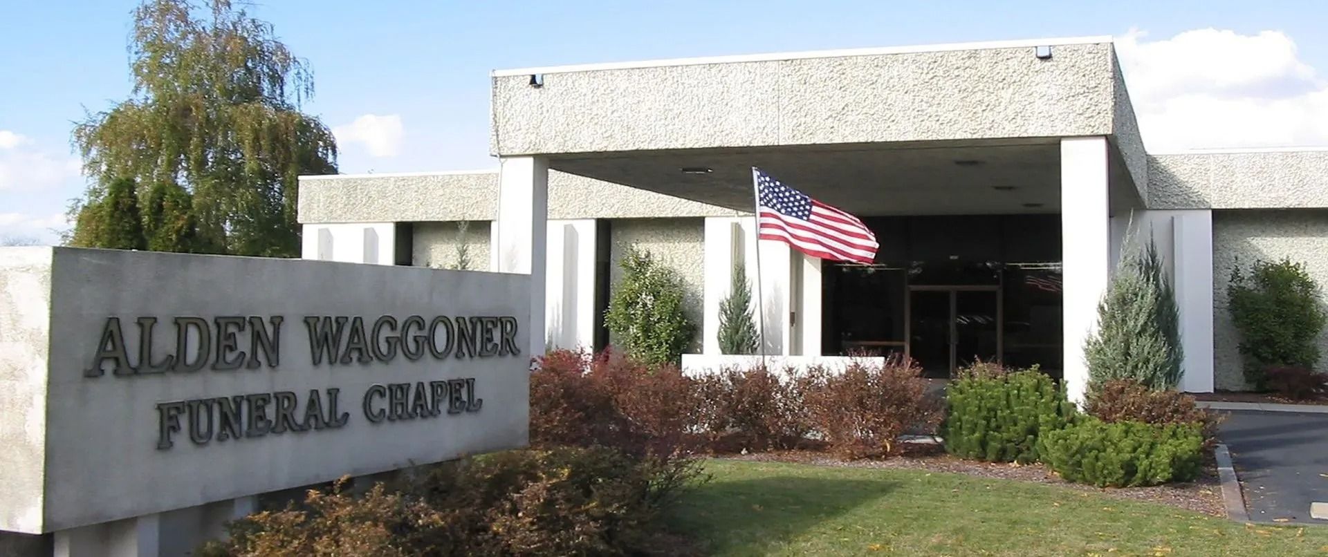 Allen-Wagner Funeral Chapel entrance with sign and an American flag outside