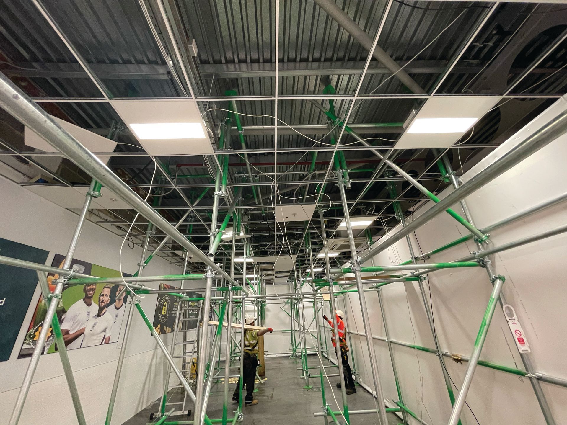 A room with a lot of scaffolding on the ceiling.
