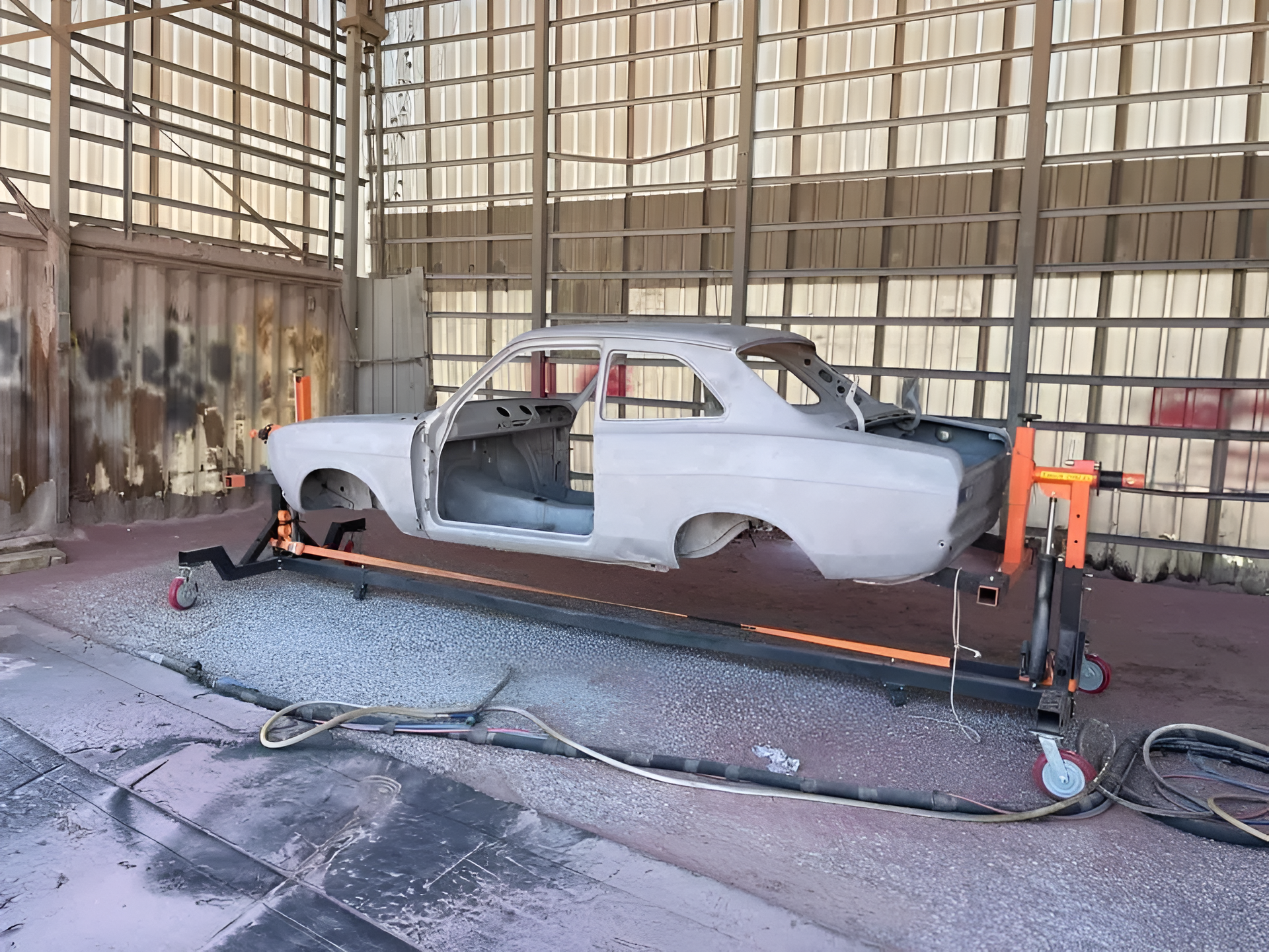 Car Body on a Rotisserie in a Workshop. Light Gray Paint — All Blast and Paint in Sarina, QLD