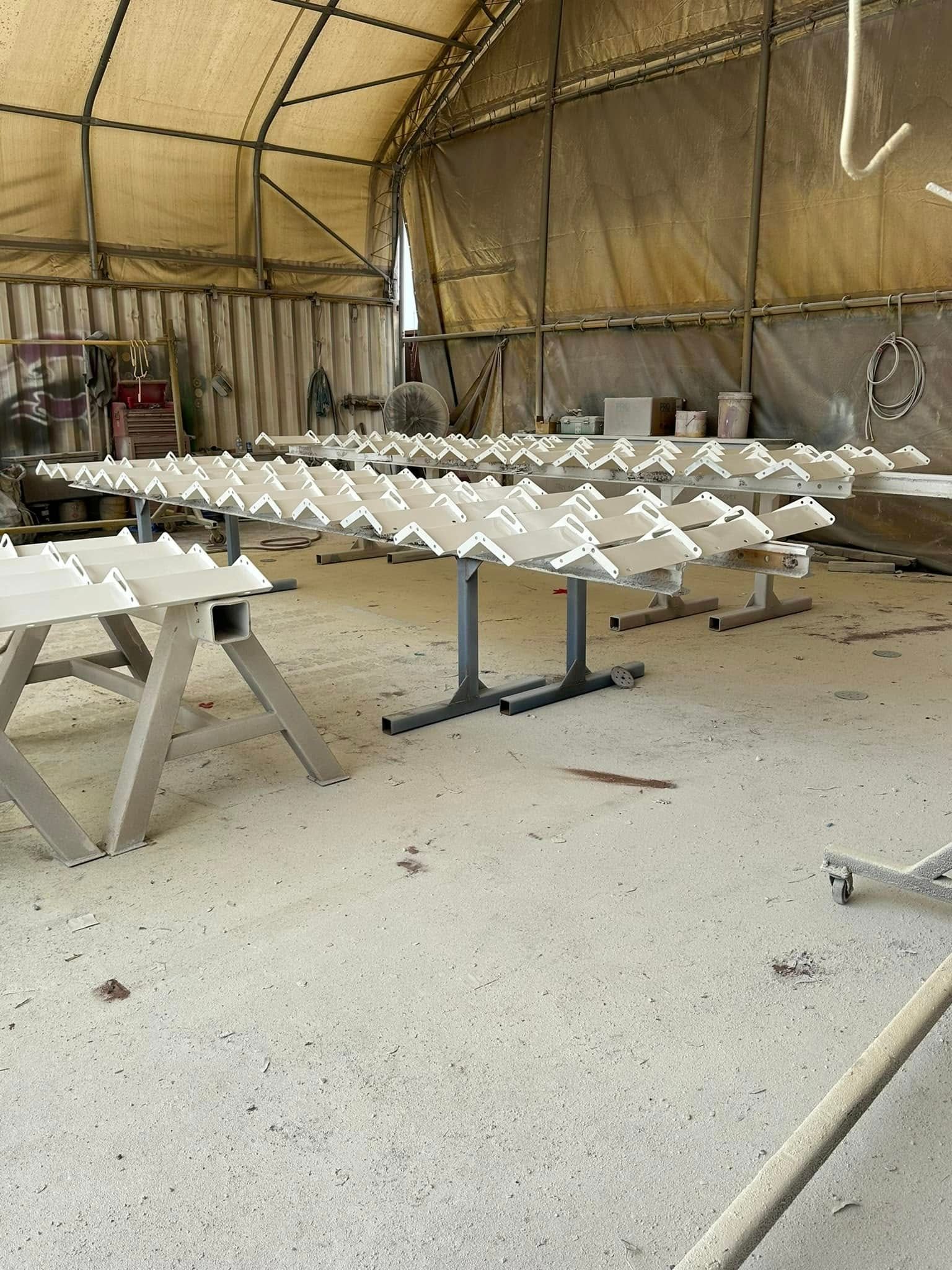 Rows of White Triangular Objects on Metal Stands — All Blast and Paint in Paget, QLD