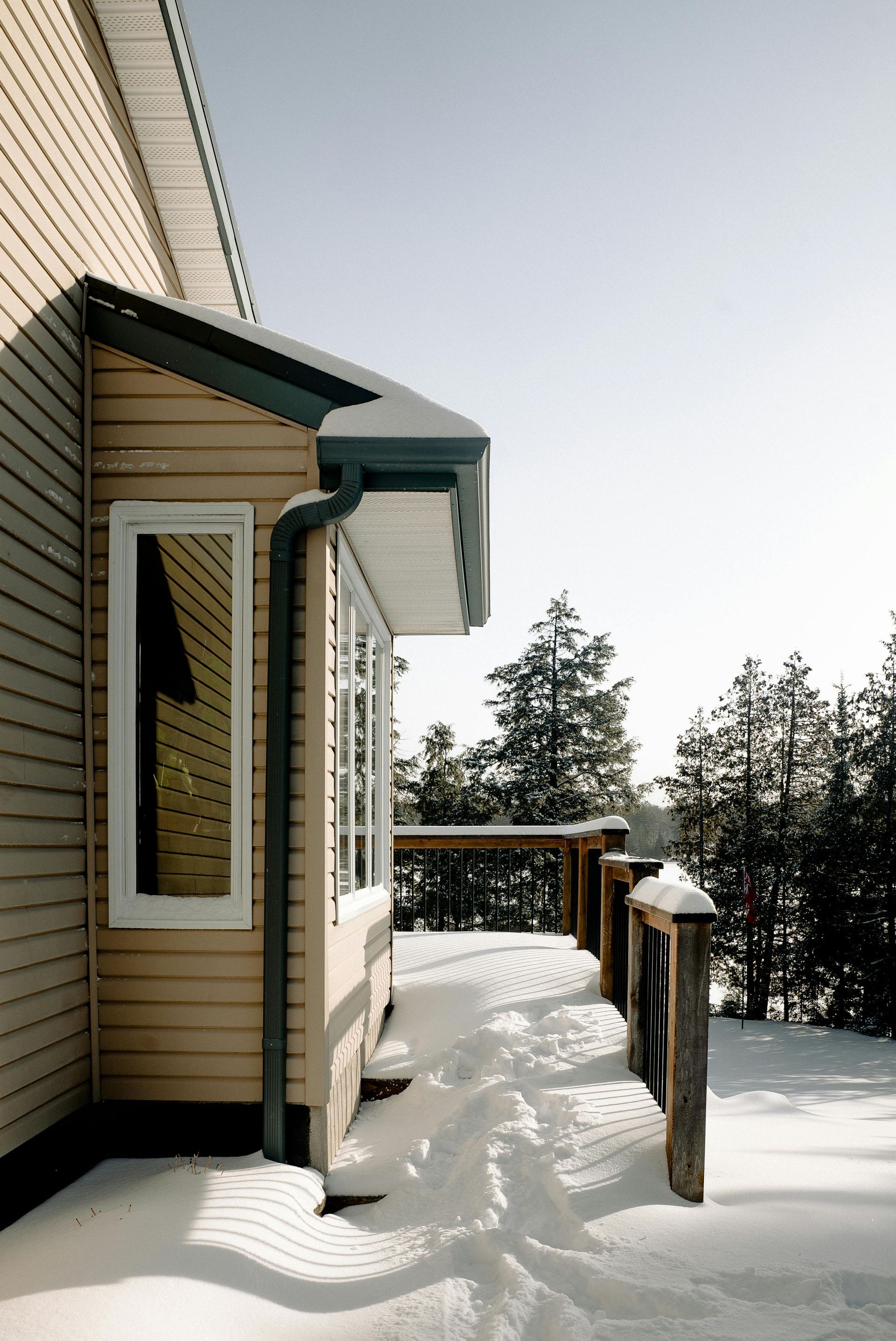 The side of a house with snow on the ground