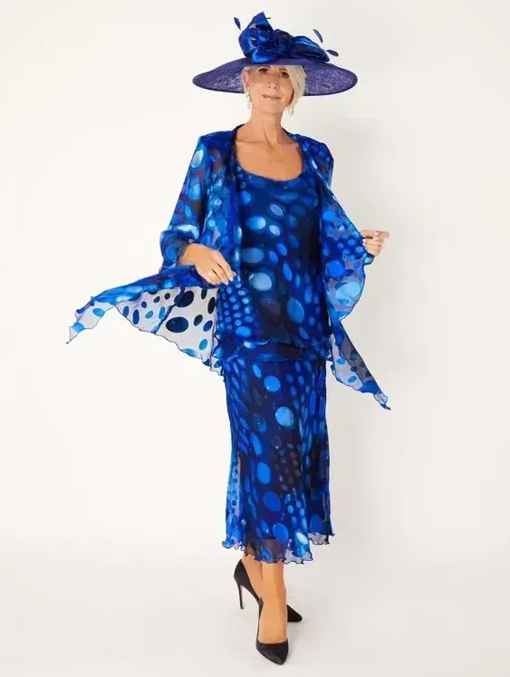 a woman wearing a blue dress and purple hat