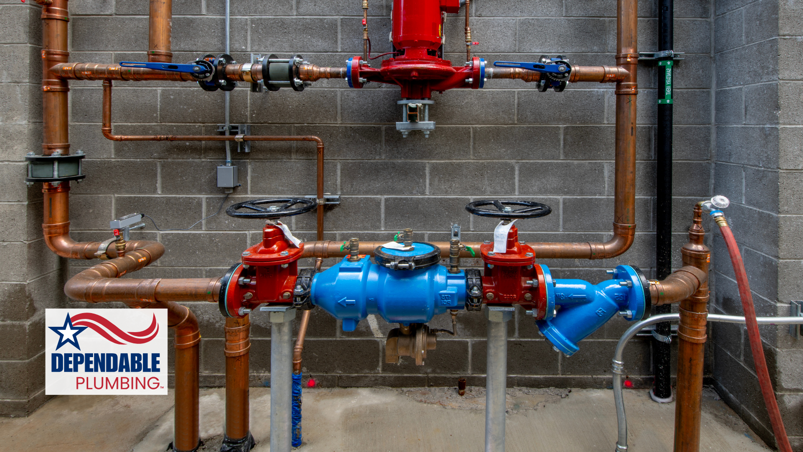 Copper pipes and valves against a brick wall, part of a building's water system.