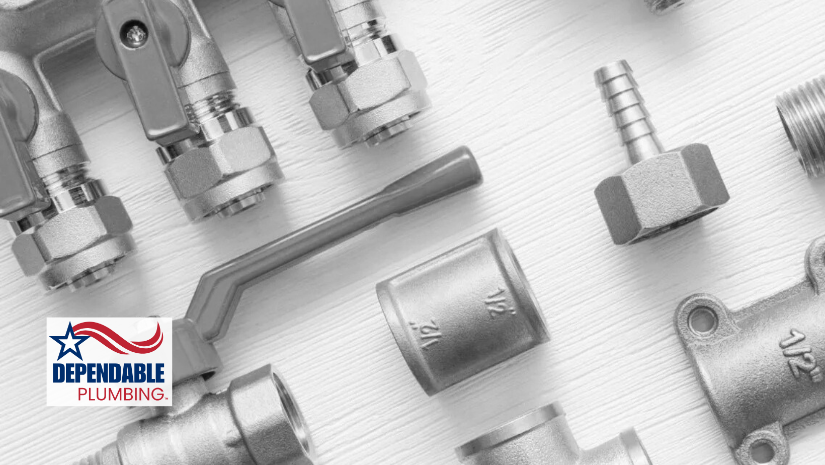 Close-up of various plumbing parts, including valves and connectors, on a light gray surface, with a logo in the corner.