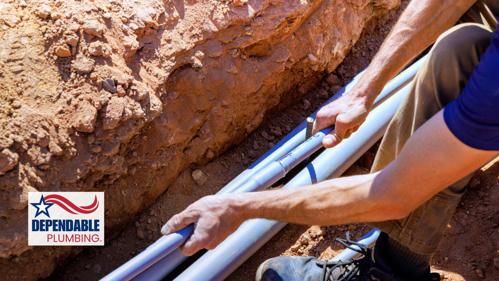 Person installing gray pipes in a trench. Plumbing logo in the corner.