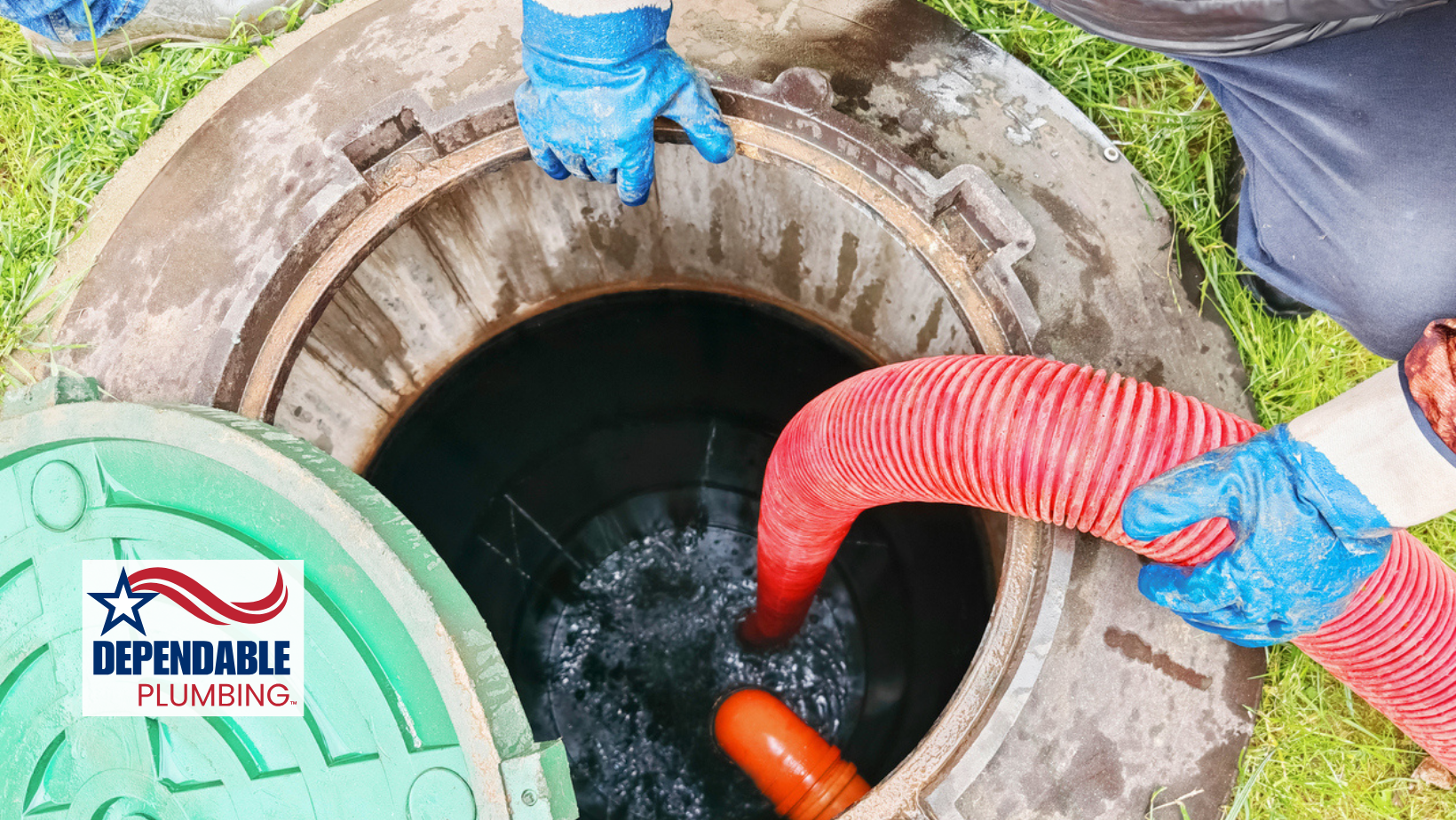 Septic tank being serviced by workers with a hose.