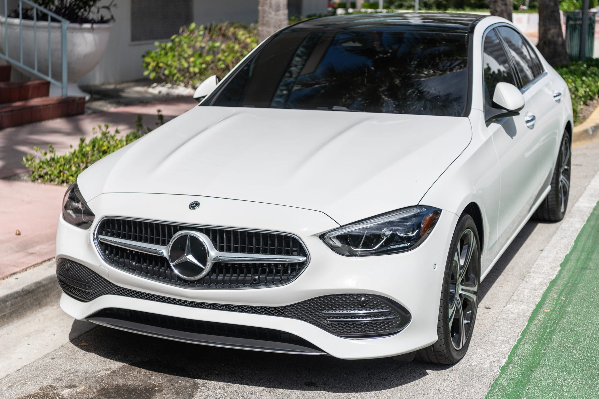 White Mercedes-Benz sedan parked outdoors, representing a European vehicle that may require professional air conditioning service and repair.