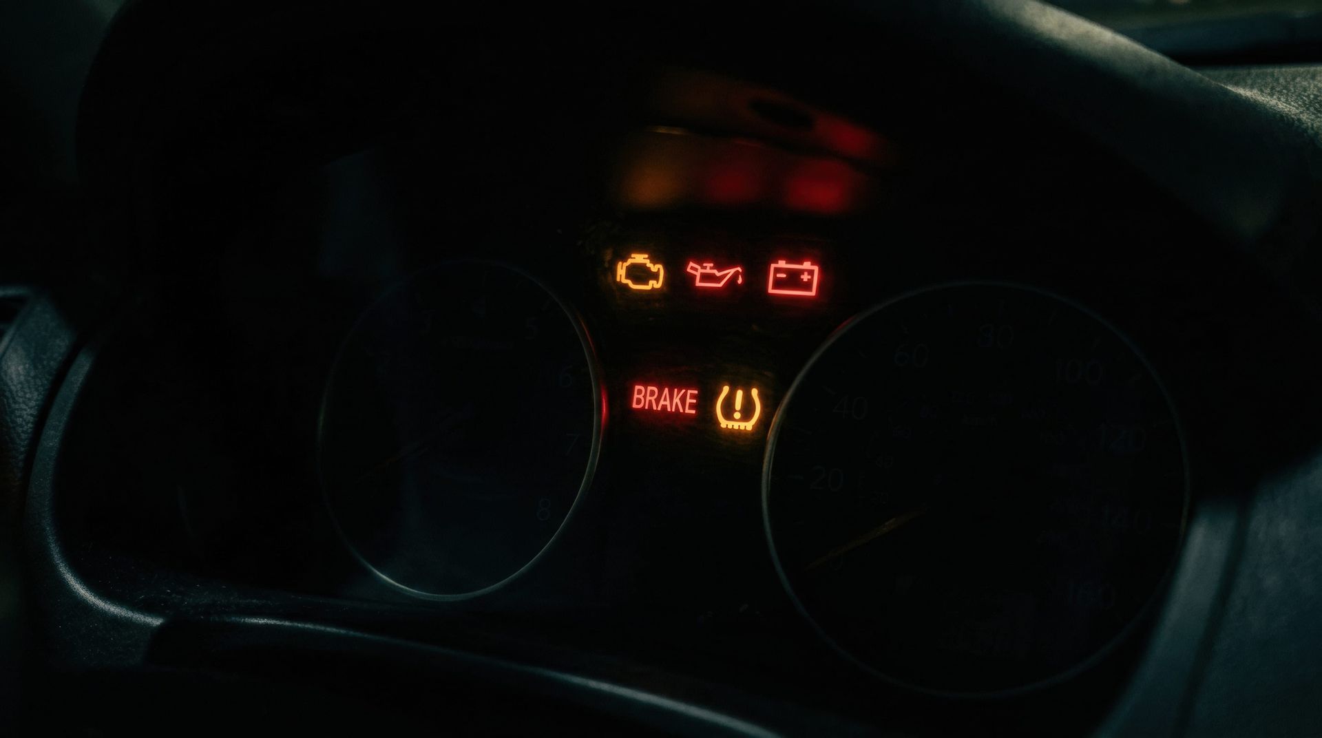 Vehicle dashboard displaying the brake warning light, signaling that the braking system should be inspected promptly.
