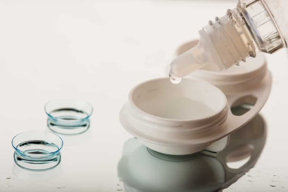 A Person is Pouring Solution Into a Contact Lens Case — Eyepower In Bargo, NSW