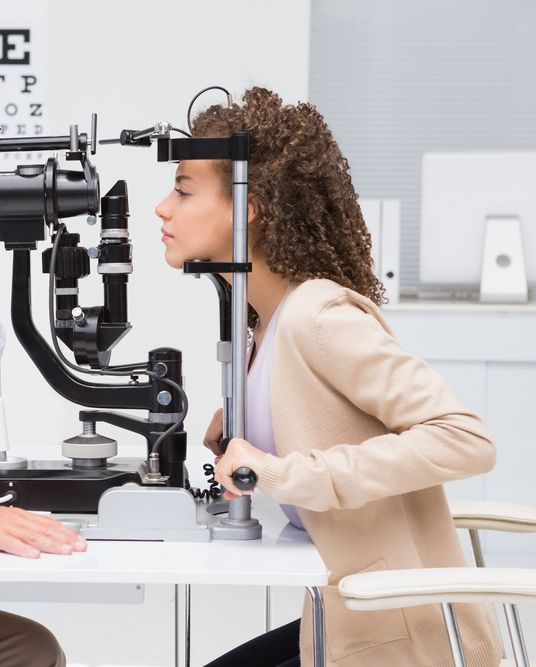 A Woman is Getting Her Eyes Examined by an Ophthalmologist — Eyepower In Tahmoor, NSW