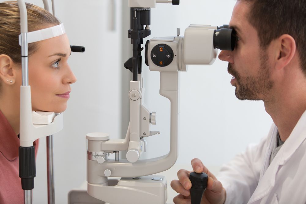 A Woman is Getting Her Eyes Examined by an Ophthalmologist — Eyepower In Tahmoor, NSW