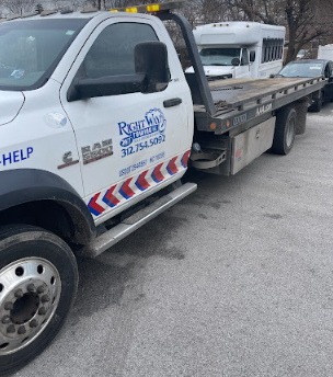A tow truck with a car on the back of it