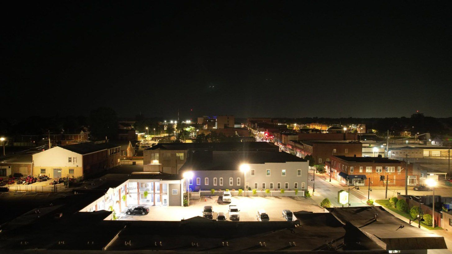 Aerial drone photo of a downtown main street at night