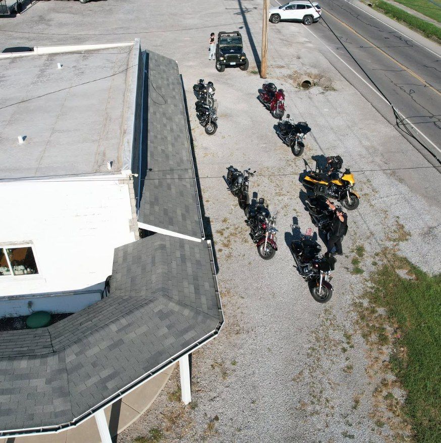 Top-down drone photo of motorcycles parked at a ride event