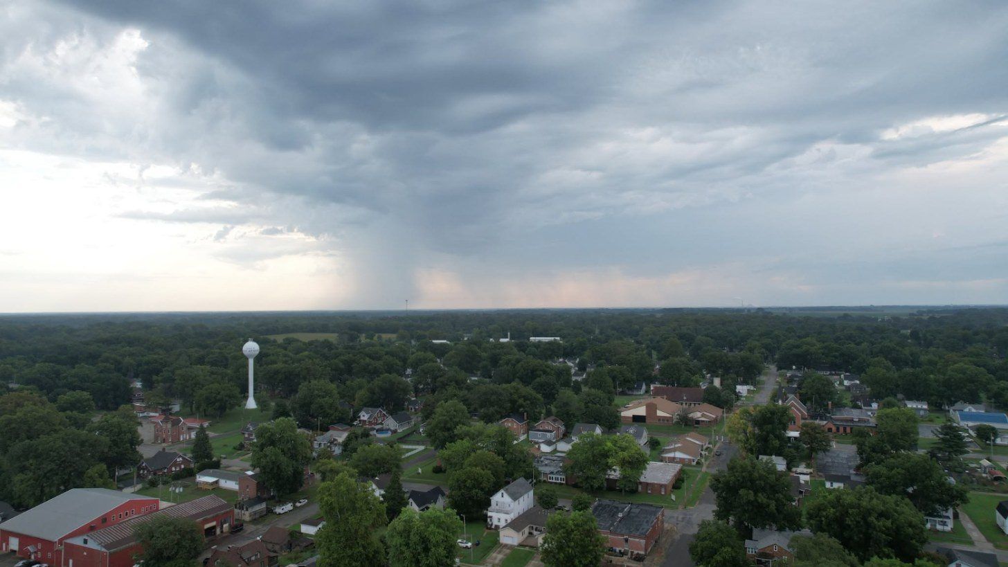 Drone photo of a storm rolling over a small town