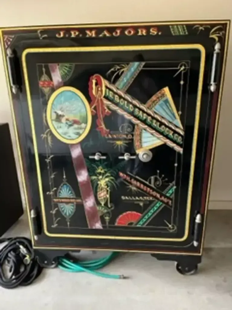 Black J.P. Majors device with colorful diagonal graphics and attached power cords