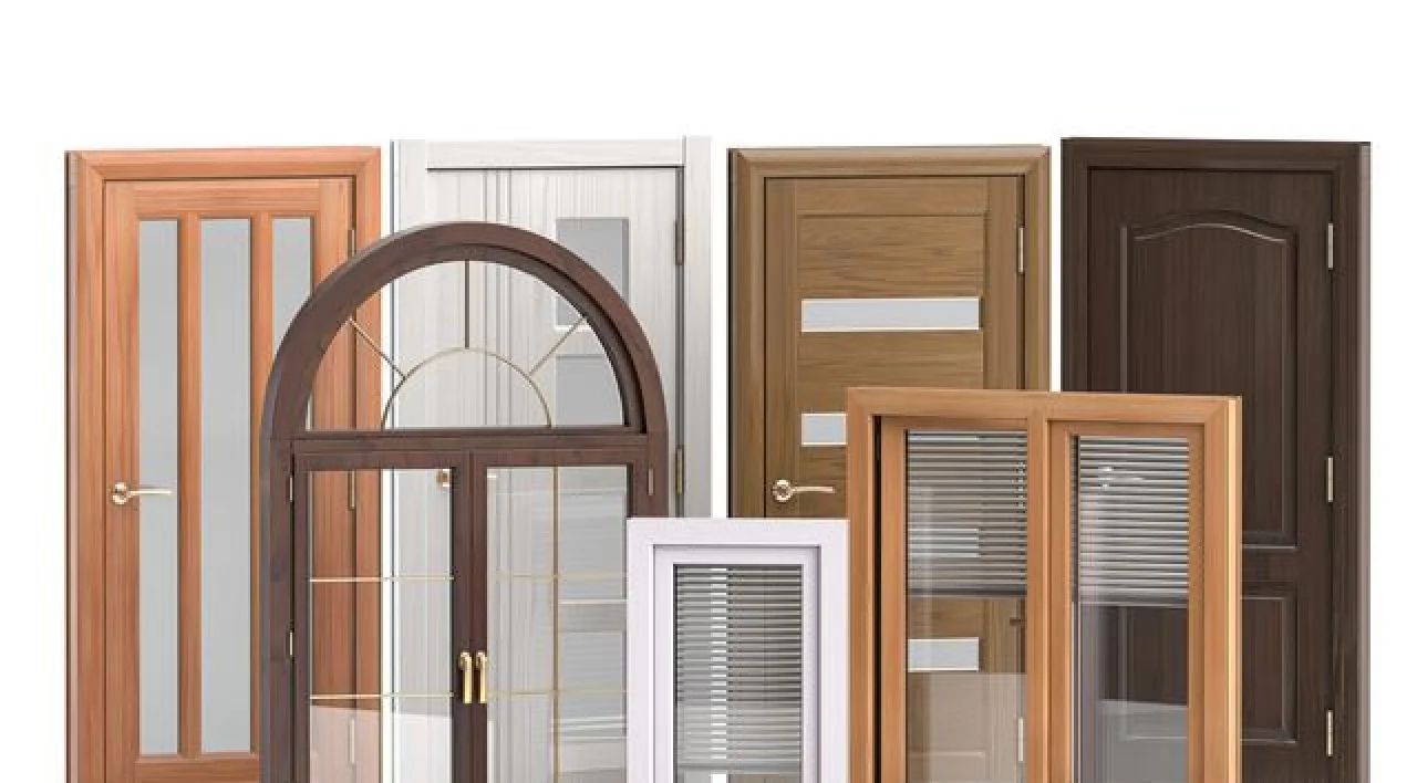 Assorted interior doors and window frames in different styles and wood tones displayed side by side.