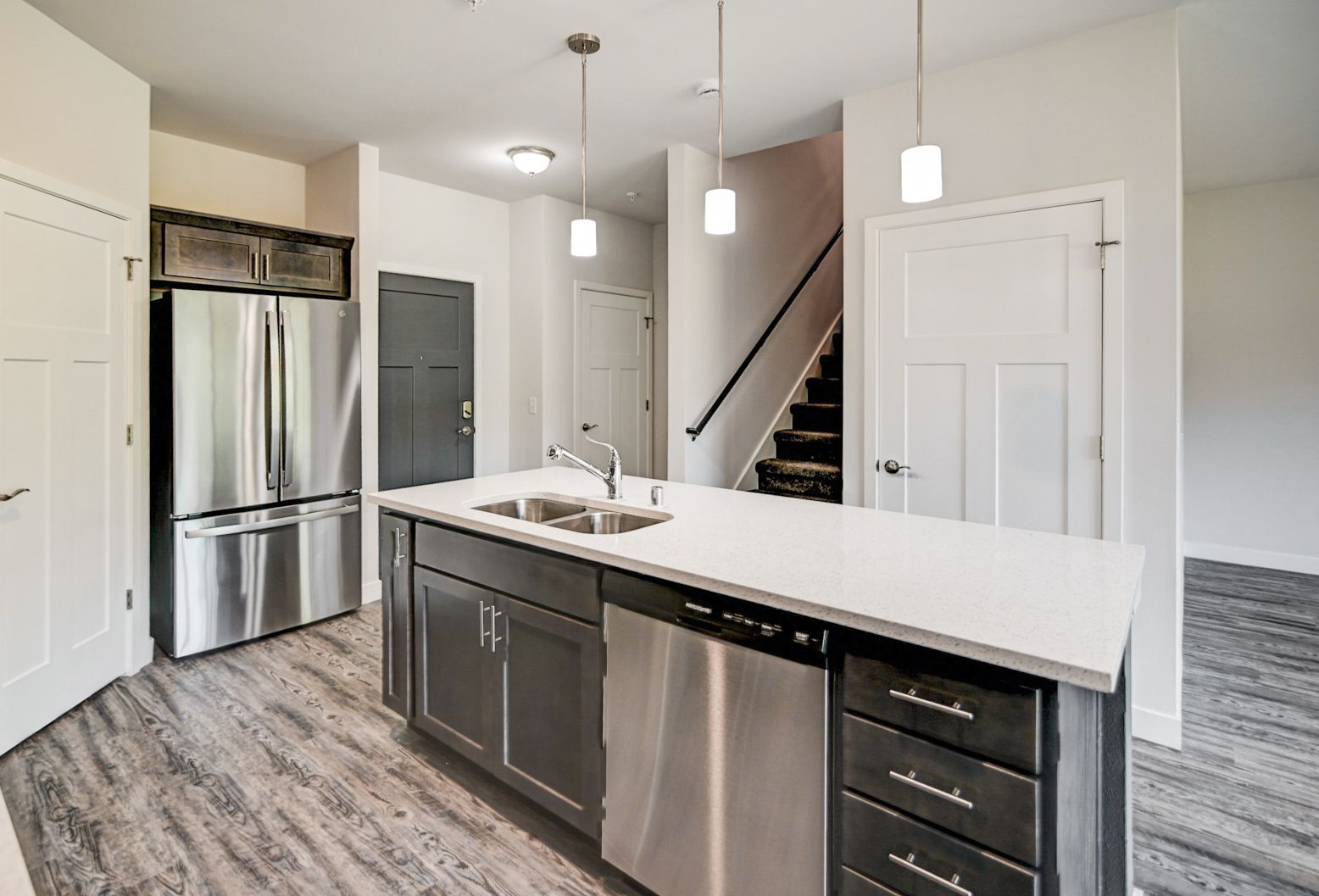 A kitchen with stainless steel appliances and a large island.