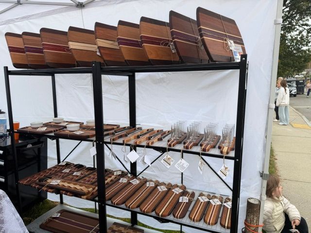 Handcrafted wood cutting boards and cheese cutters on display