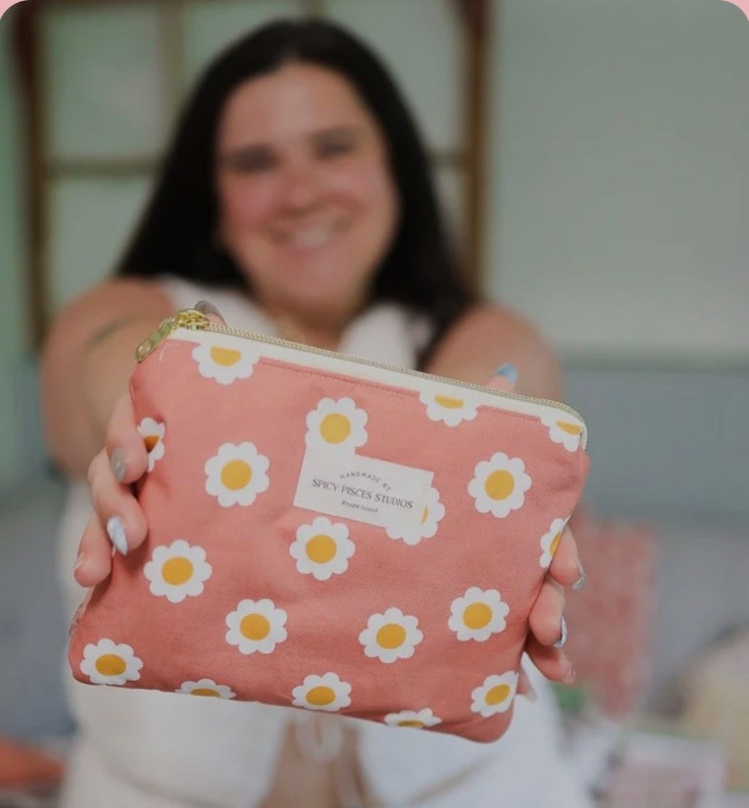 Kimberly McCormick holding a floral Spicy Pisces Studios pouch
