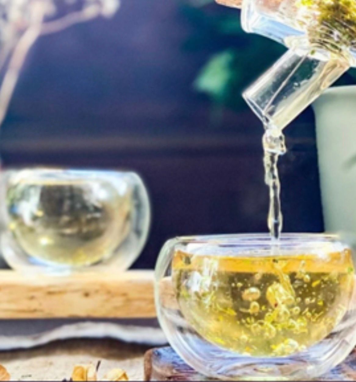 Herbal tea being poured into a glass cup
