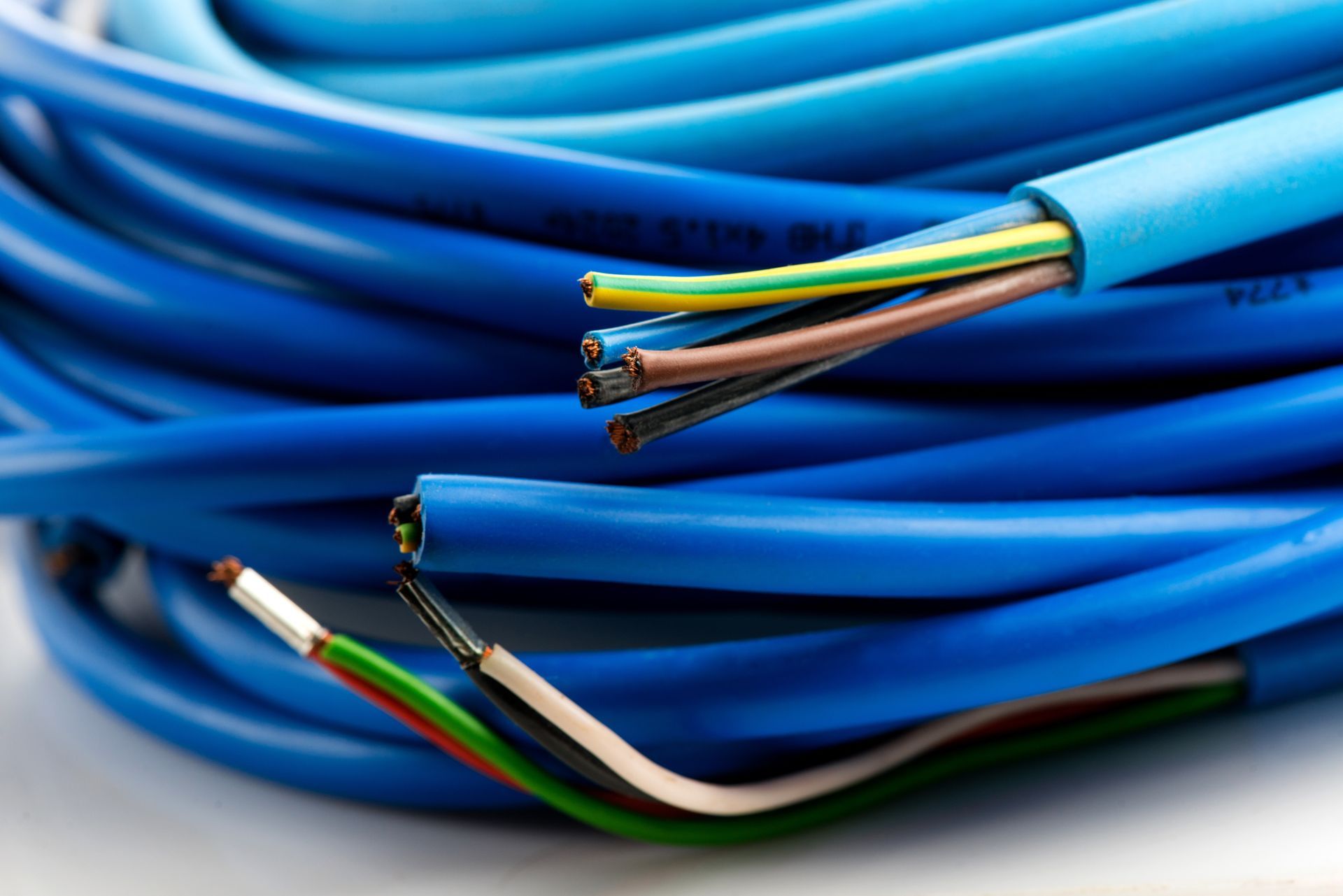 Coiled blue electrical cables with exposed multicolored wire ends