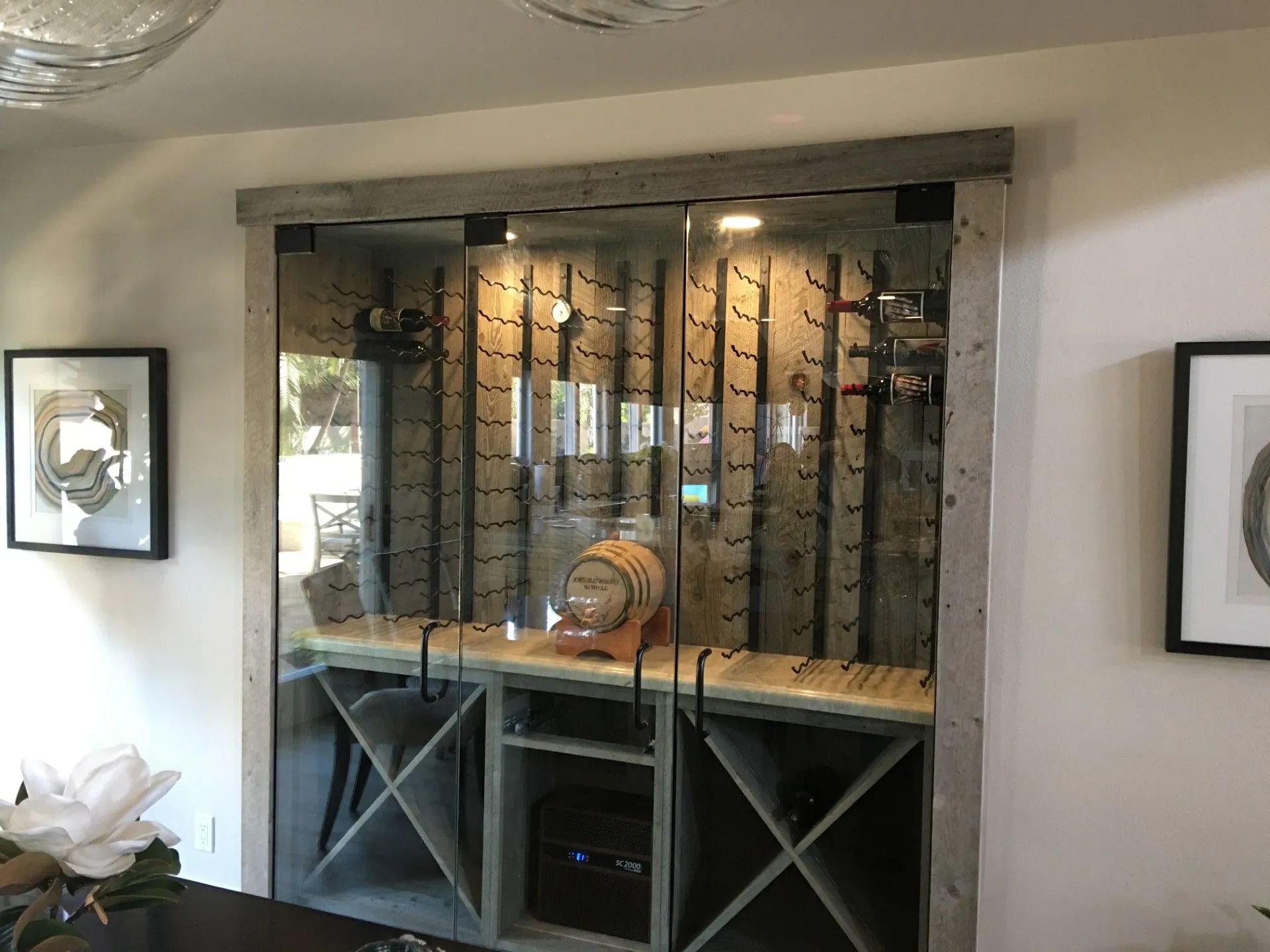 Wooden wine cabinet with bottles and wine storage, illuminated with soft lighting.