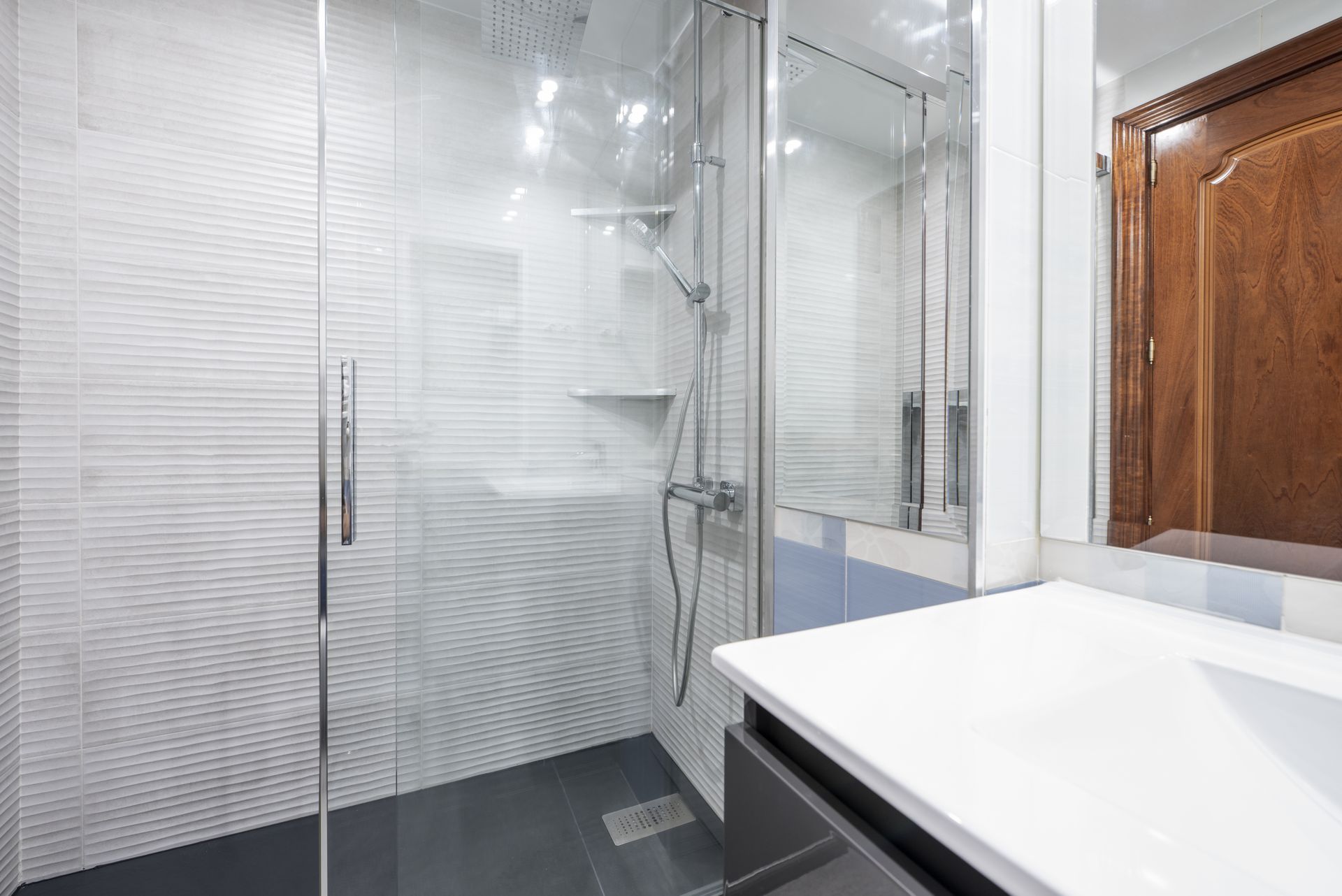 Walk-in shower showcasing sliding frameless glass doors. Walk-in shower showcasing sliding frameless glass doors.