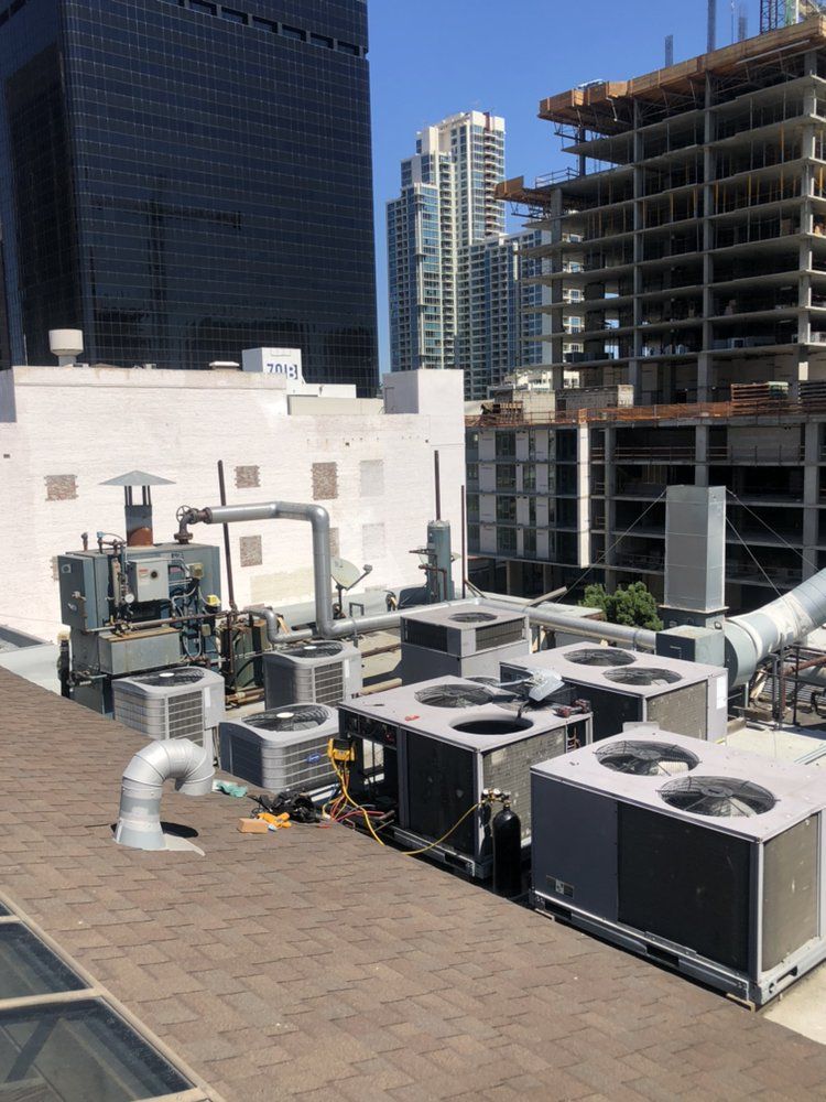 A rooftop with a lot of air conditioners on it