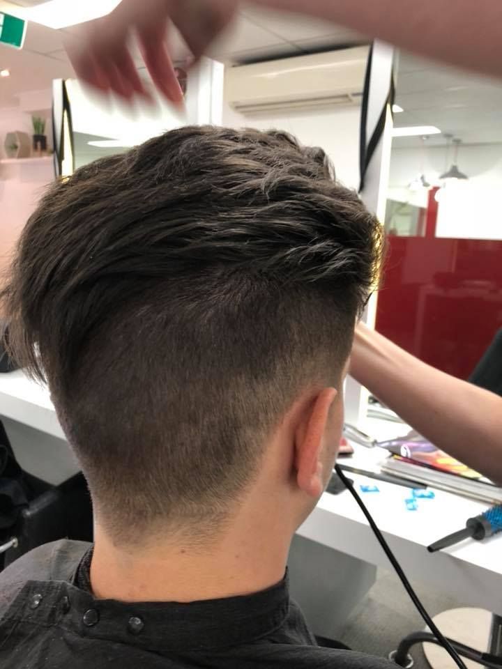 A Man Is Getting His Hair Cut in A Salon — Hair It Is In Balgownie, NSW