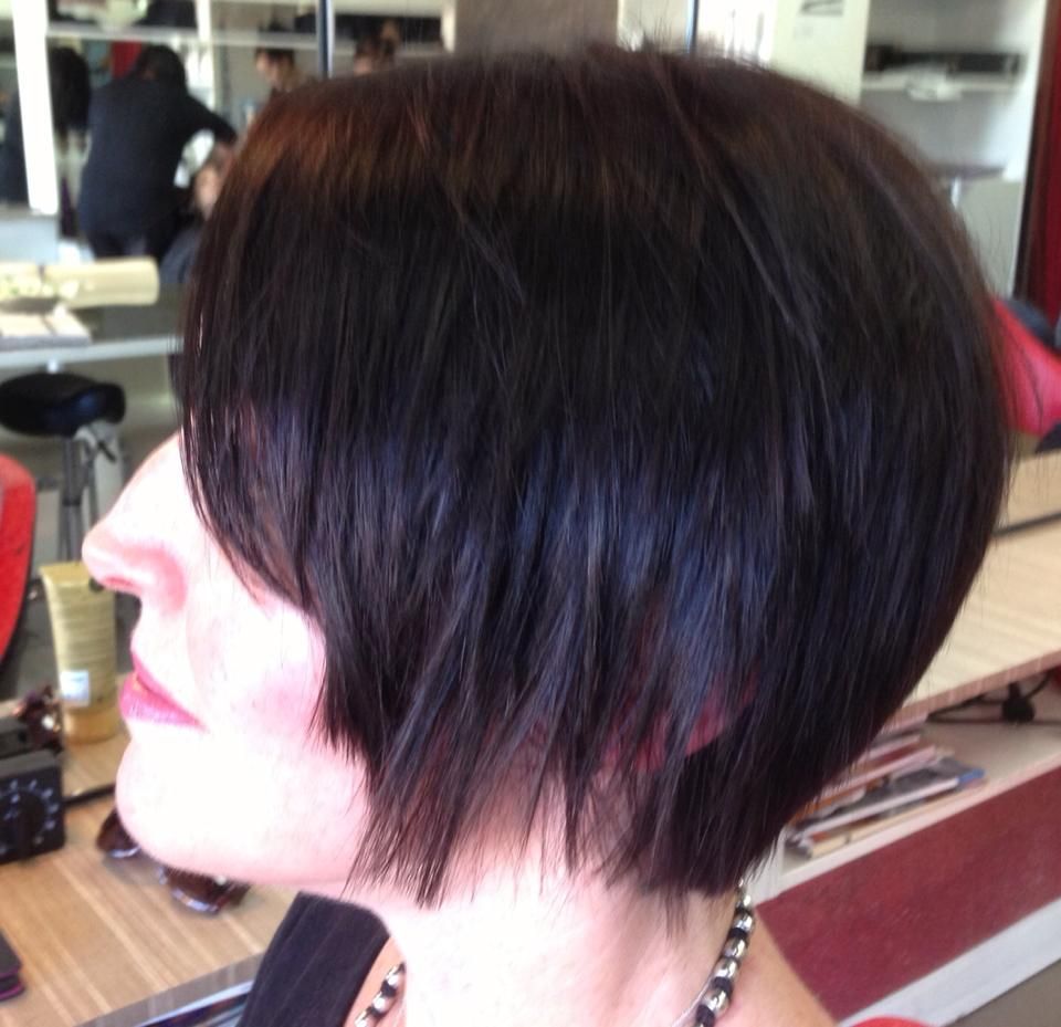 A Woman with Short Dark Hair Is Sitting in A Chair — Hair It Is In Balgownie, NSW