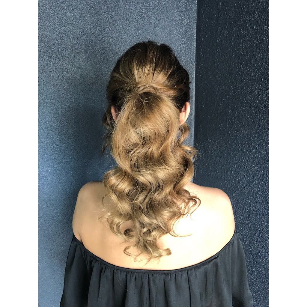 The Back of A Woman Wearing a Black Off the Shoulder Top and A Ponytail — Hair It Is In Balgownie, NSW