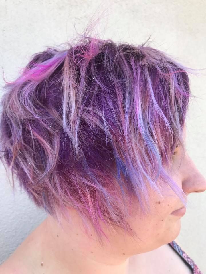 A Woman with Purple and Pink Hair Is Standing in Front of A White Wall — Hair It Is In Balgownie, NSW