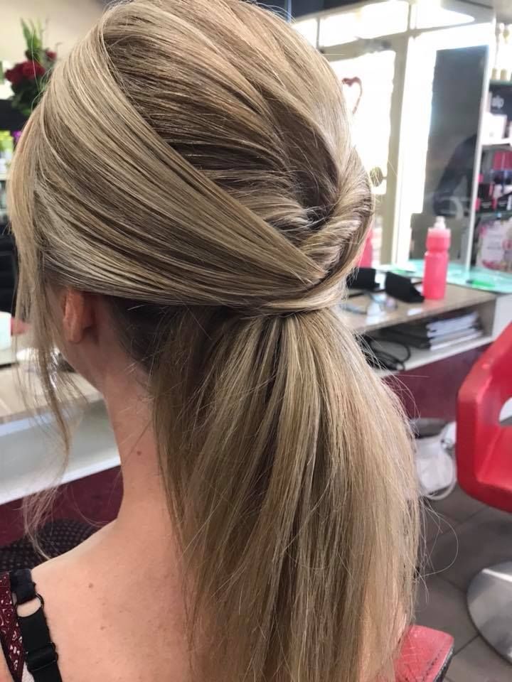 A Woman Is Wearing Her Hair in A Ponytail in A Salon — Hair It Is In Balgownie, NSW