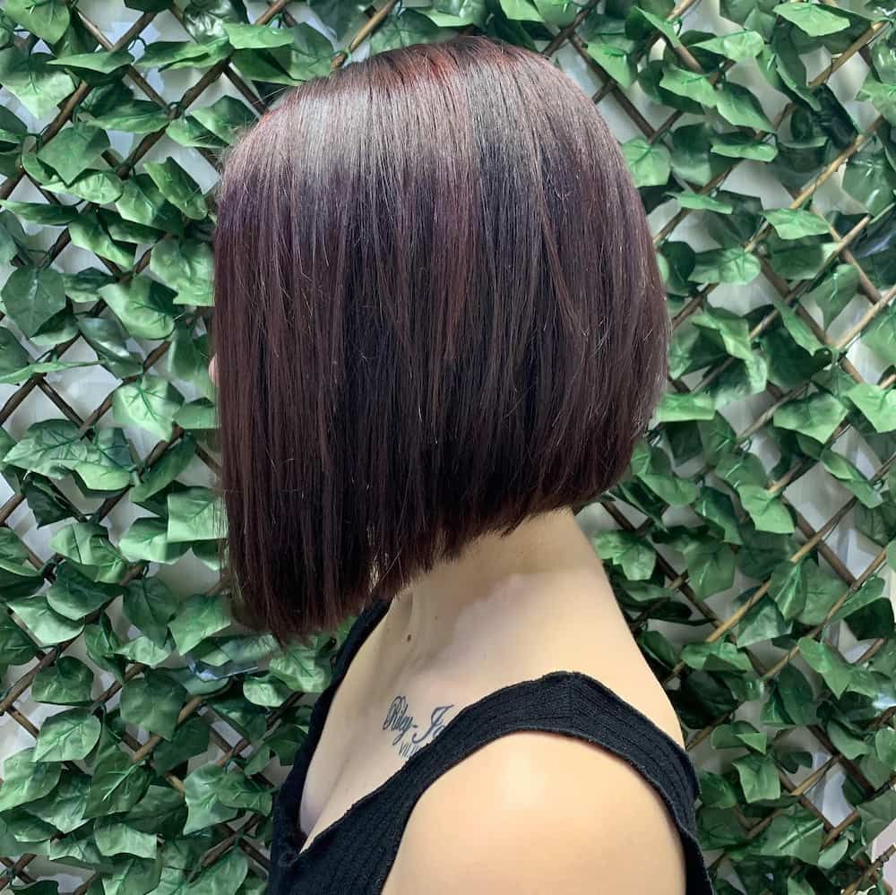 A Woman with A Bob Hairstyle Is Standing in Front of A Hedge — Hair It Is In Balgownie, NSW