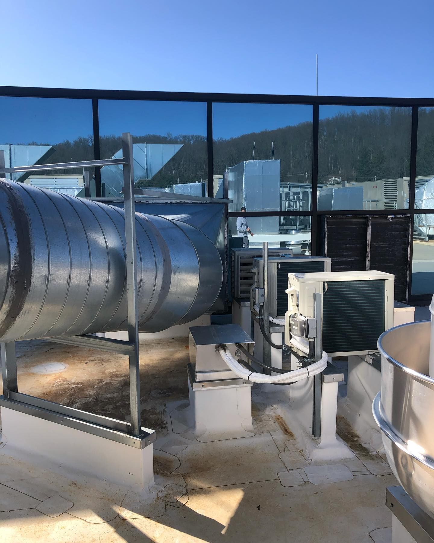 A rooftop with a lot of pipes on it