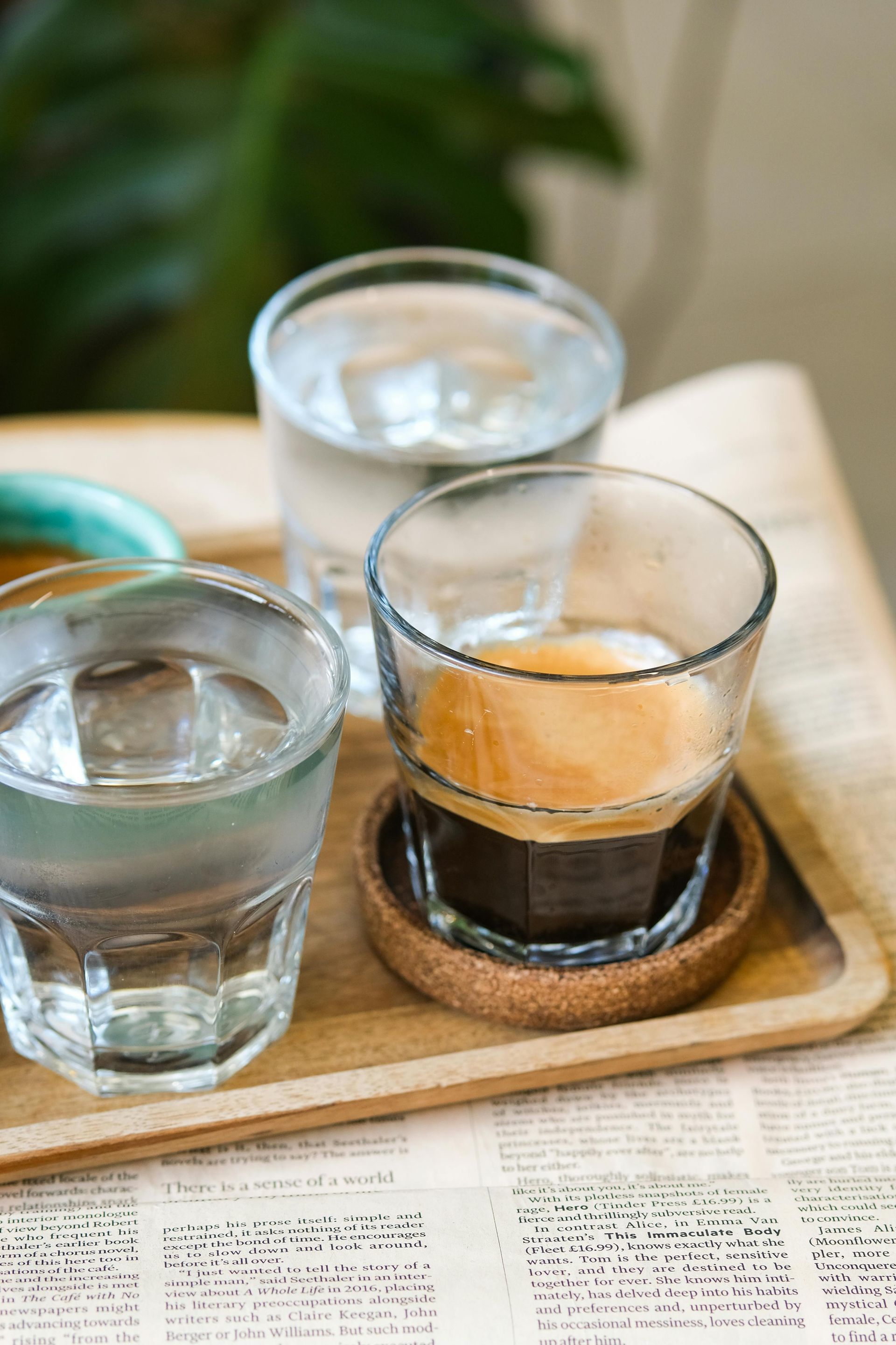 Espresso with water glasses on a tray; a caffeinated beverage setting.
