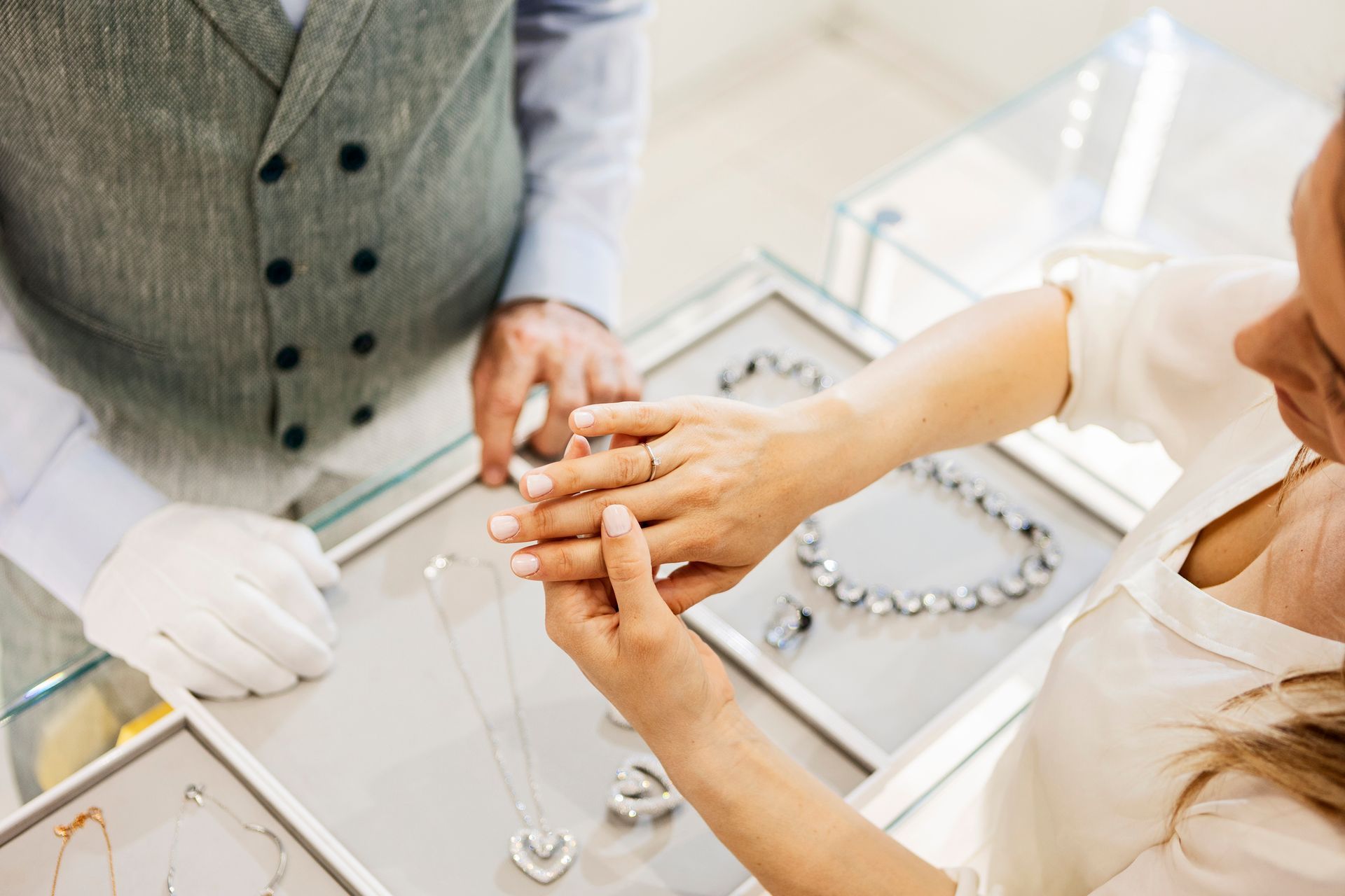 A woman trying on a ring at a jeweler. A woman trying on a ring at a jeweler.