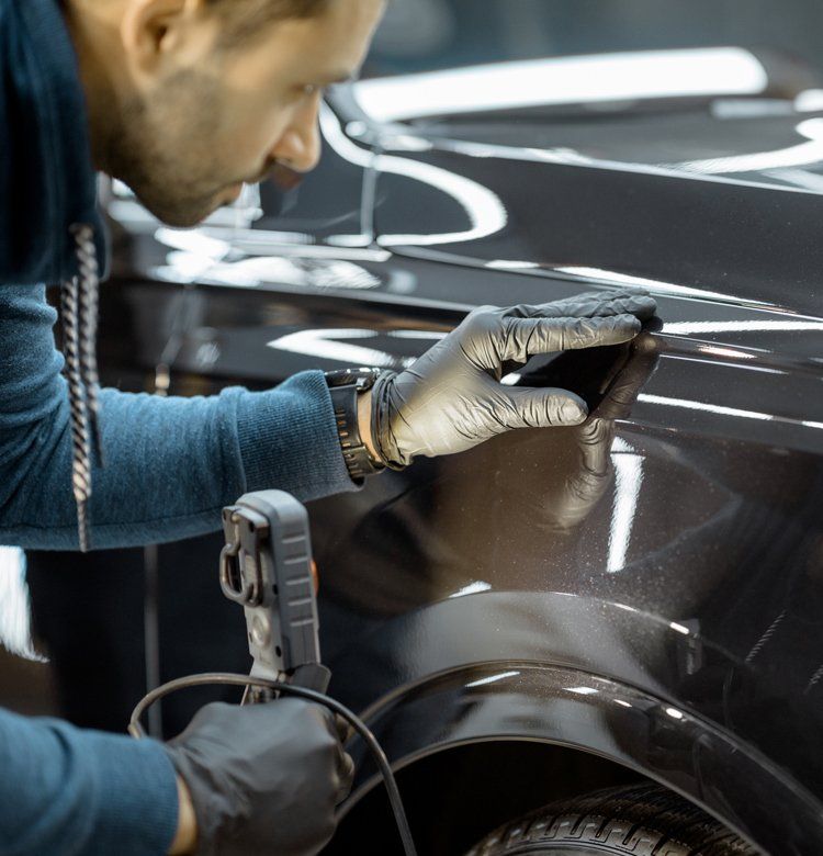 Worker Examining the Car — Pleasant Grove, UT — Sandpiper Autobody Worker Examining the Car — Pleasant Grove, UT — Sandpiper Autobody