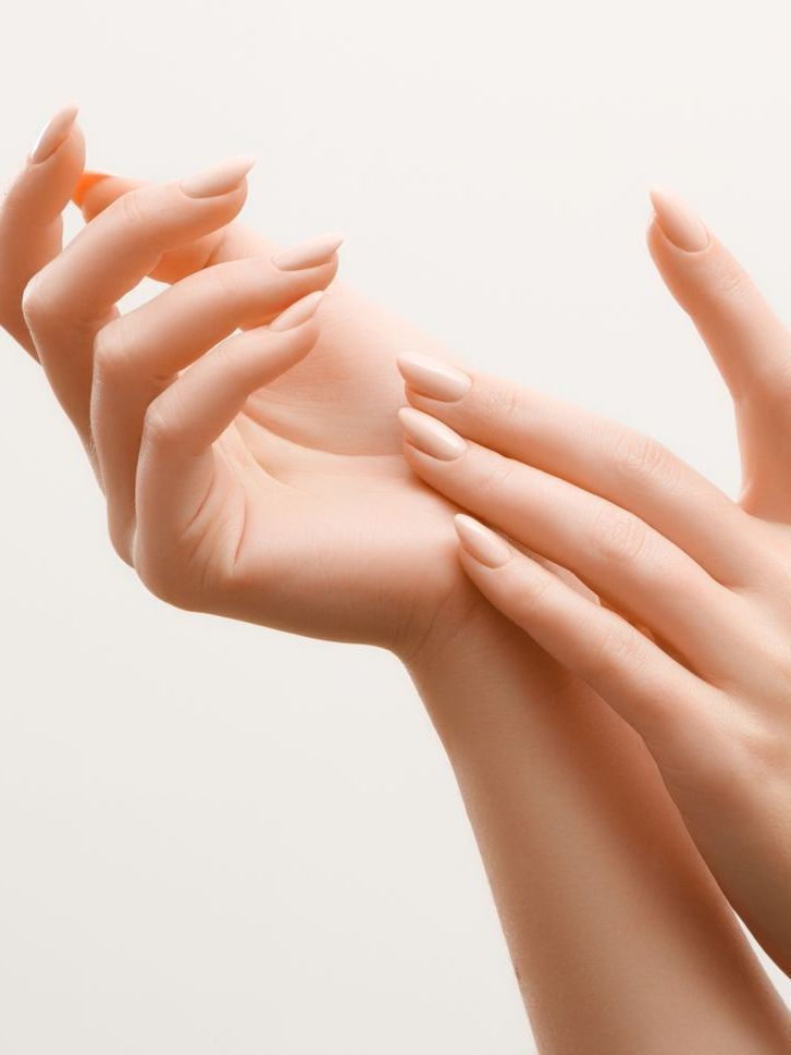 A close up of a woman 's hands on a white background