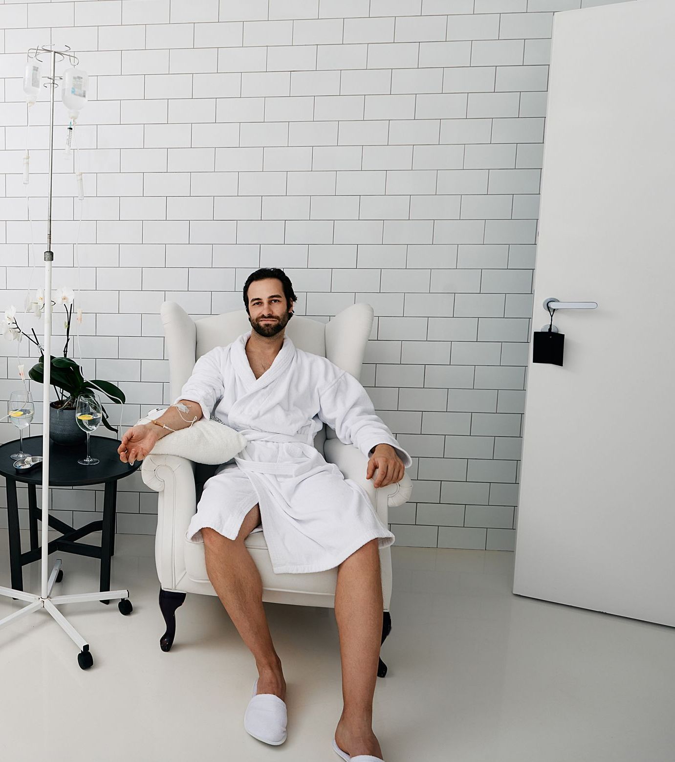 A man in a white robe is sitting in a chair