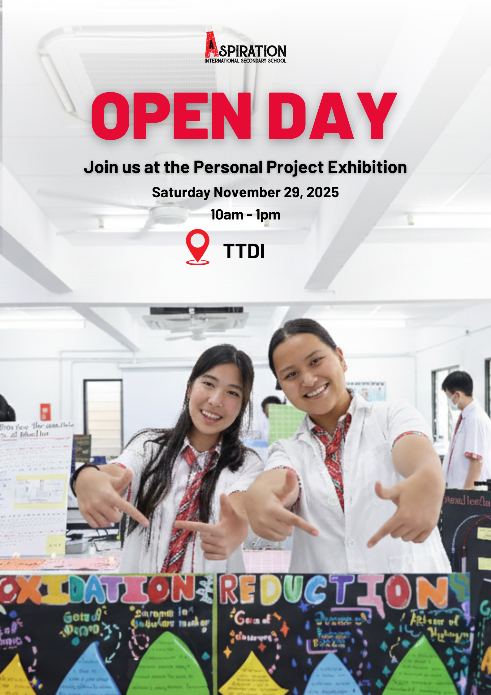 Two students point to their project boards during an Aspiration school open day in TTDI on November 25, 2023.