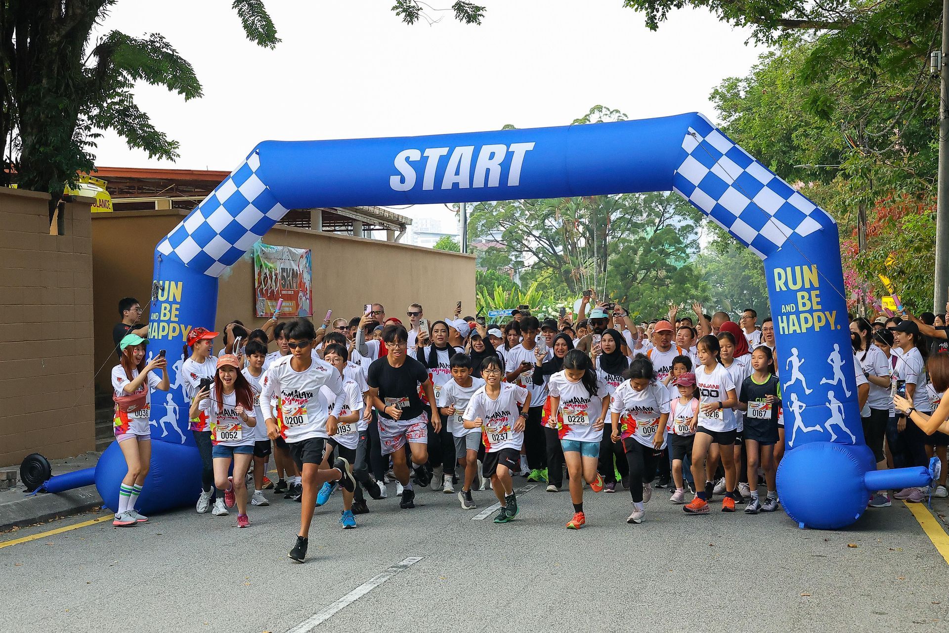 Students and participants showing enthusiasm, teamwork, and discipline as they begin a fun run together.