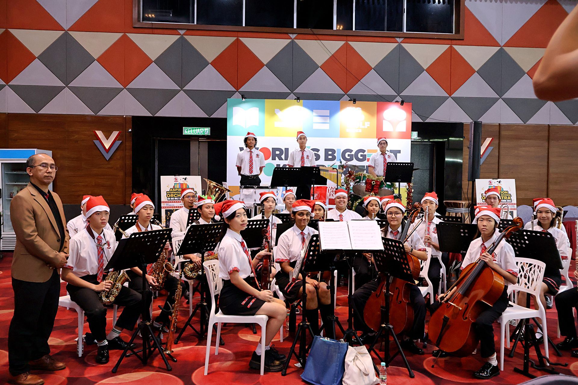 Group of student orchestra performing at school Christmas event.