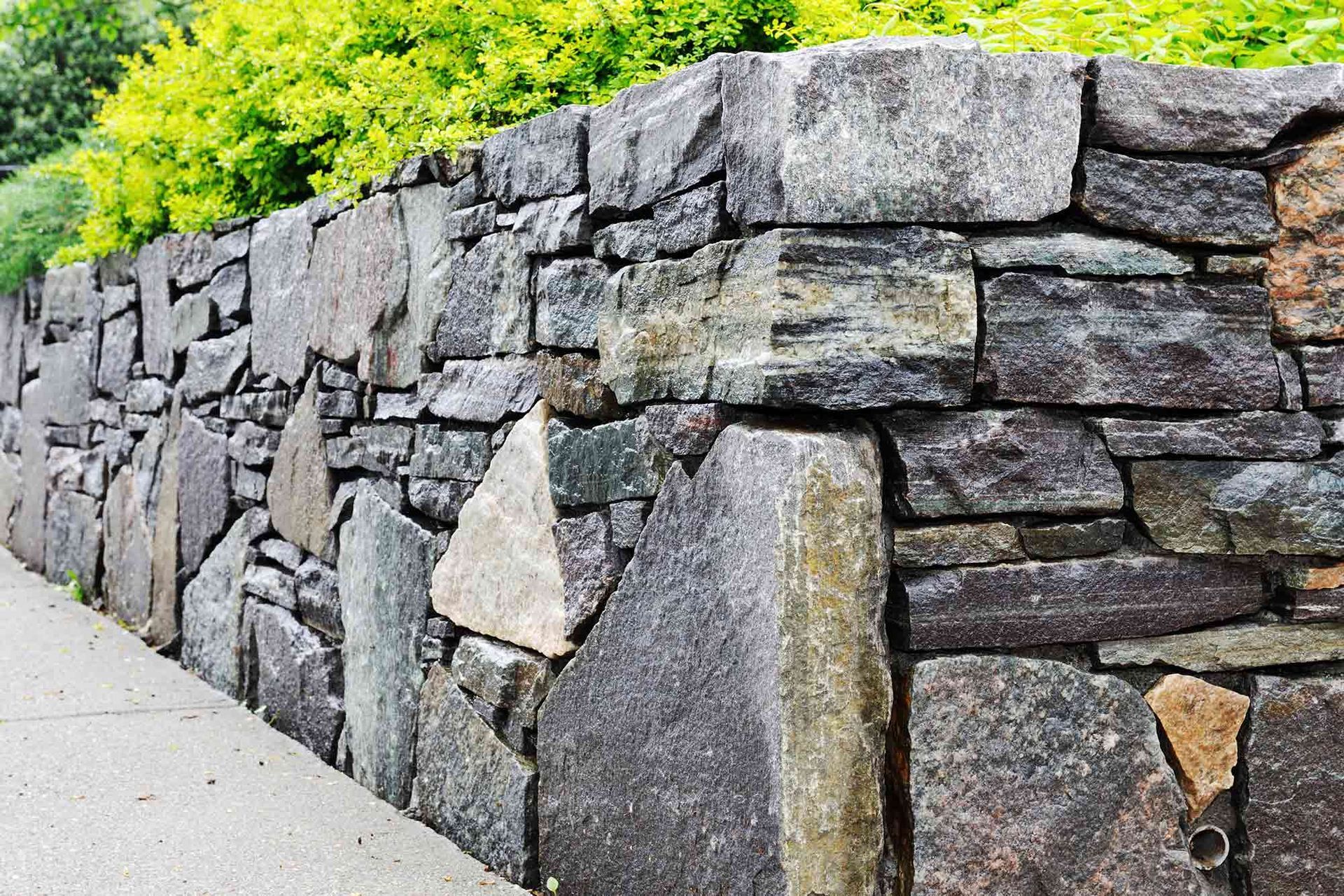 Stone Wall Along a Sidewalk