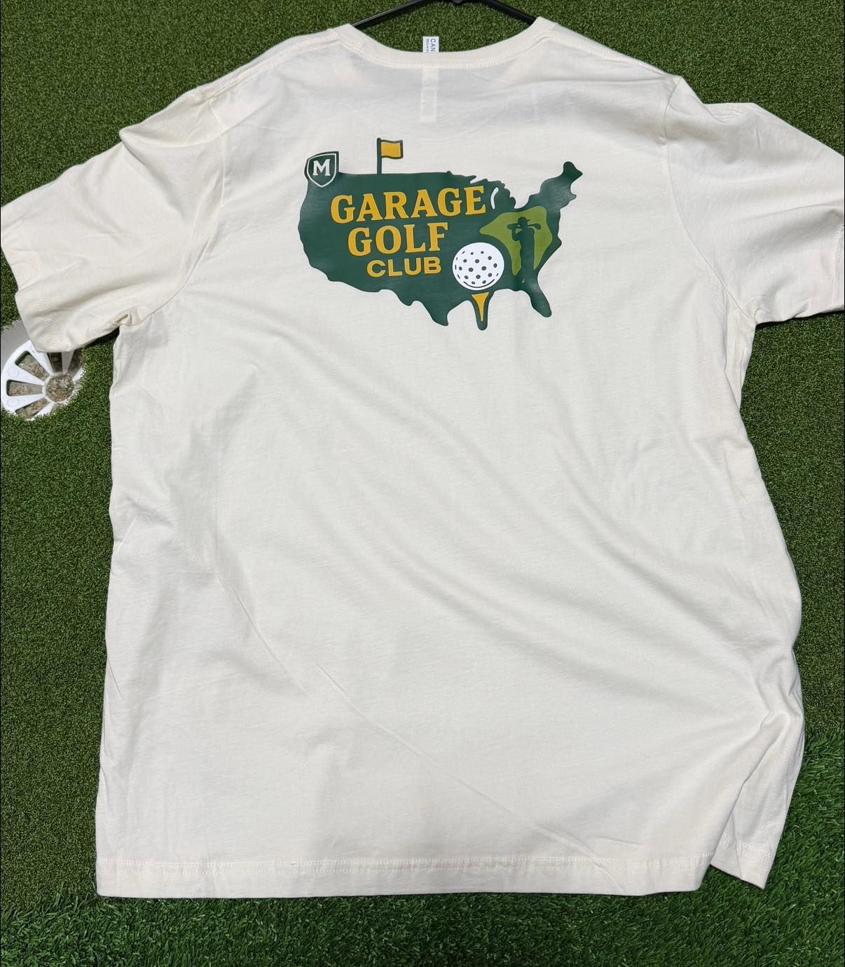 Cream-colored t-shirt with a green map of the USA and 