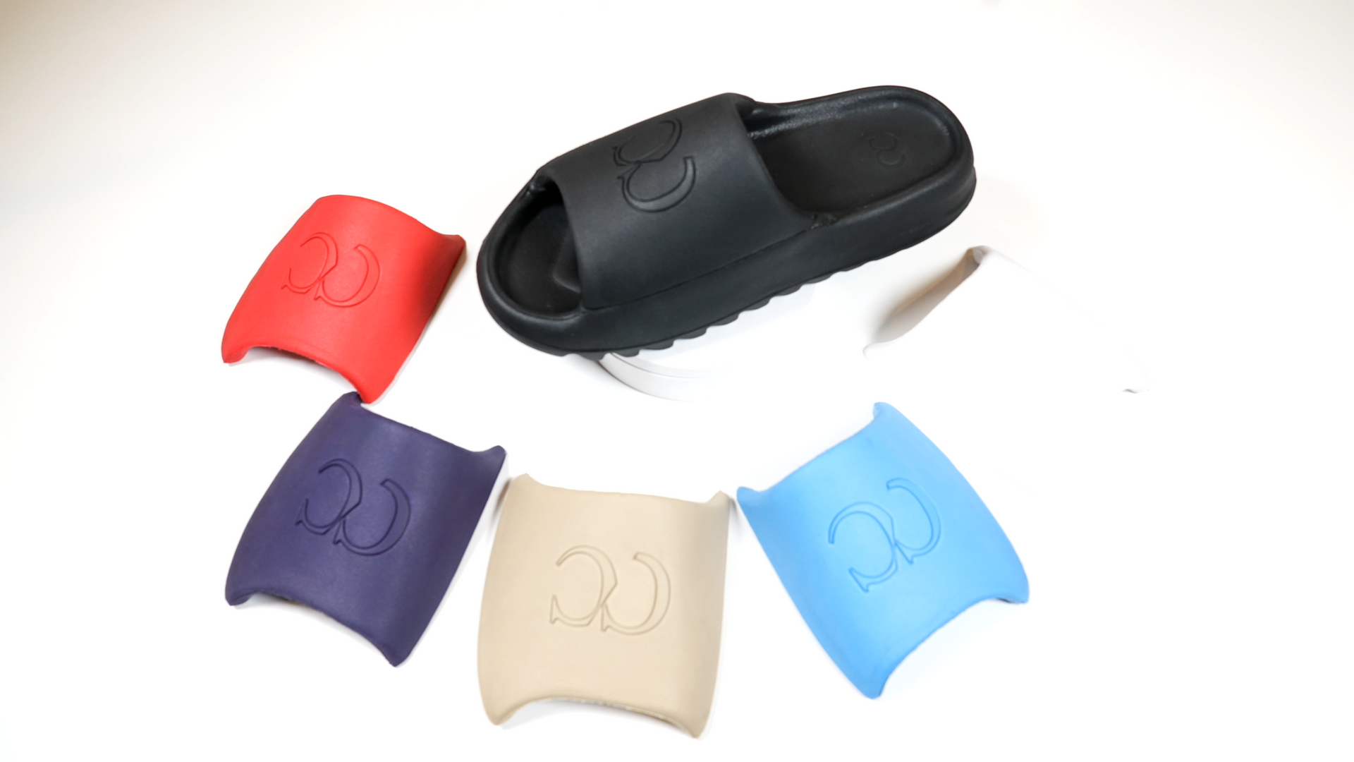 A pair of sandals are sitting on top of a white surface.