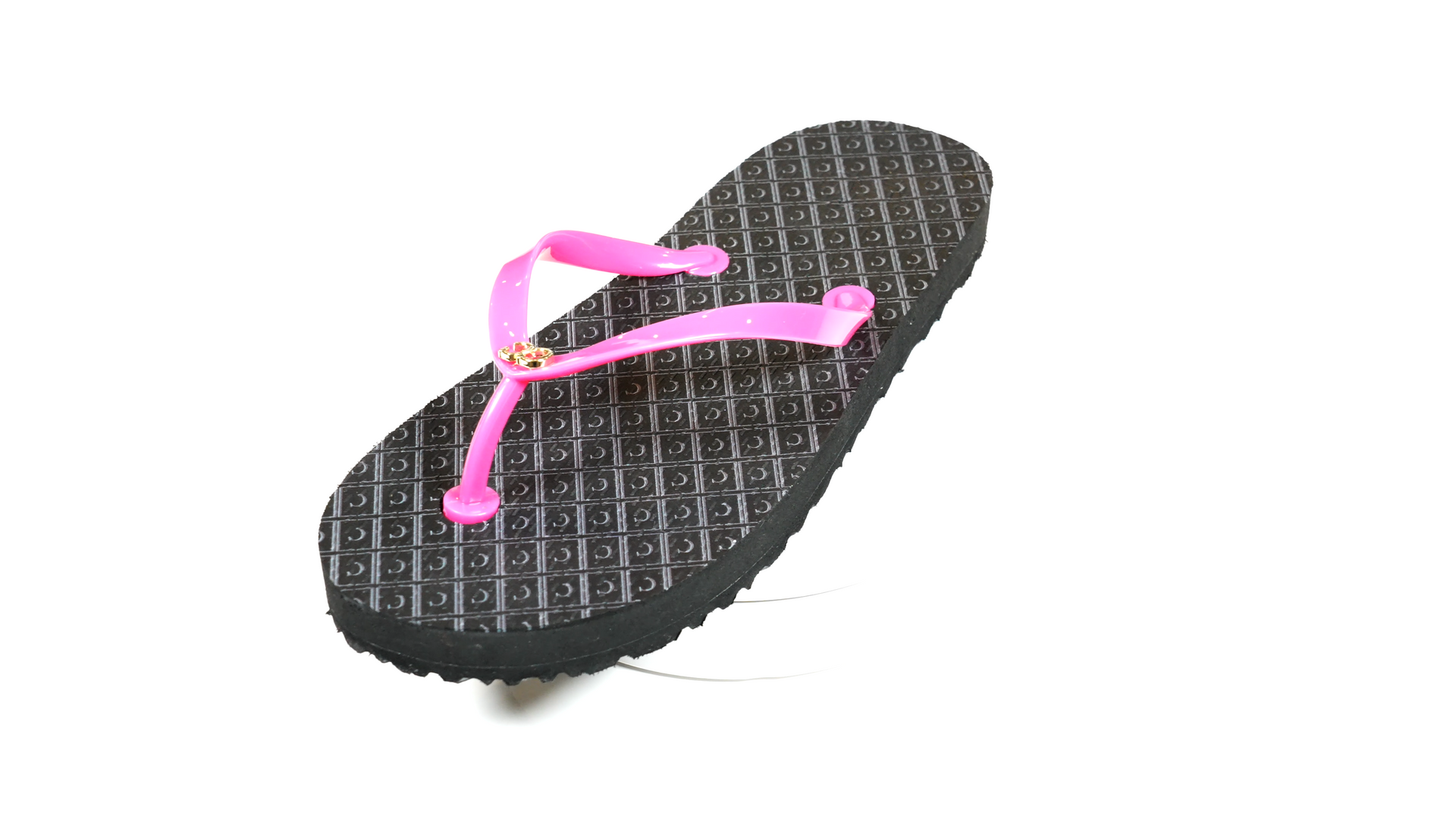 A pair of black flip flops with a pink strap on a white background.